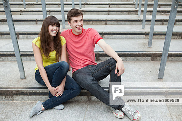 Young couple sitting on steps
