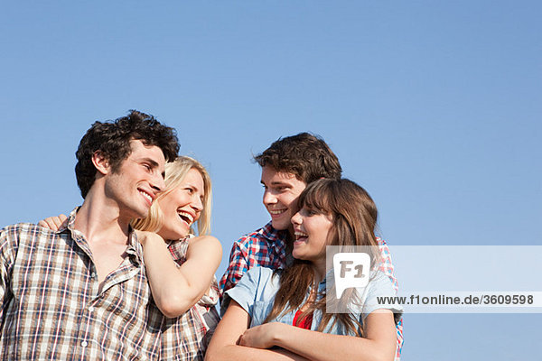 Two young couples and blue sky