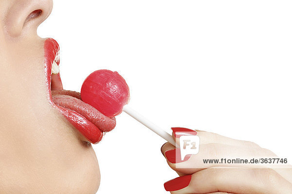 Woman licking a lollipop  close-up mouth