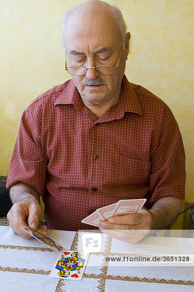 Pensioner playing cards