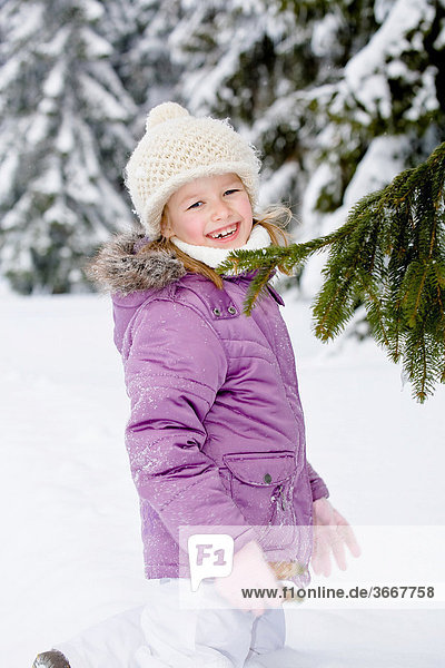 Girl in snow-covered forest