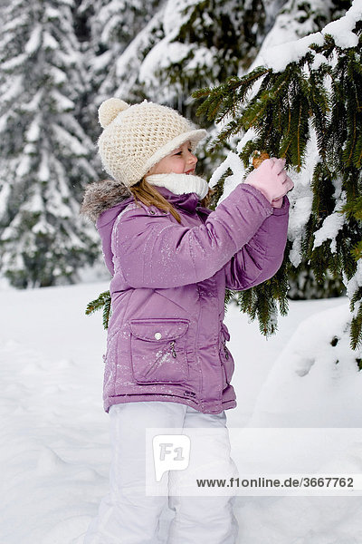 Girl in snow-covered forest