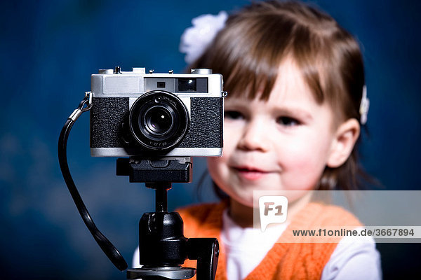 Little Girl with an old-fashioned camera