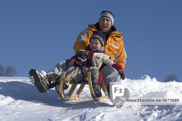 Familiy in the winter sleigh sledging on a sledge