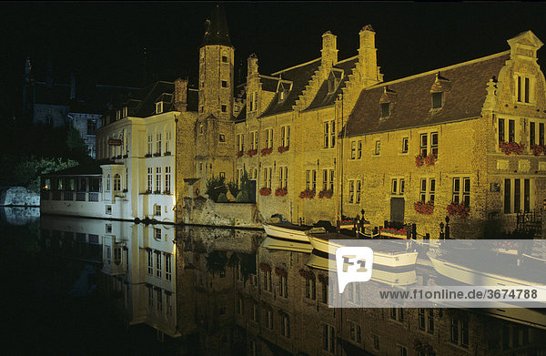 Waterway of Rozenhoed Kaai at night city of Brugge Belgium