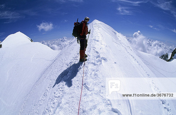 Woman on the summit ridge of Ludwigshoehe Valais Switzerland