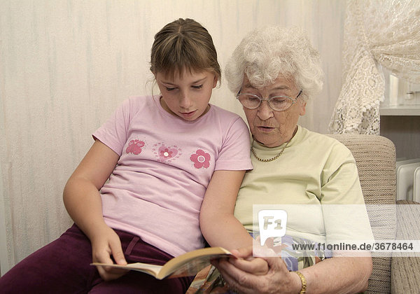 Girl reads with granny