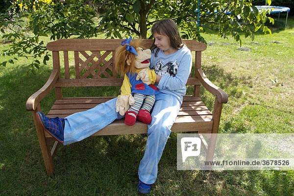 Girl with handdoll at garden bank