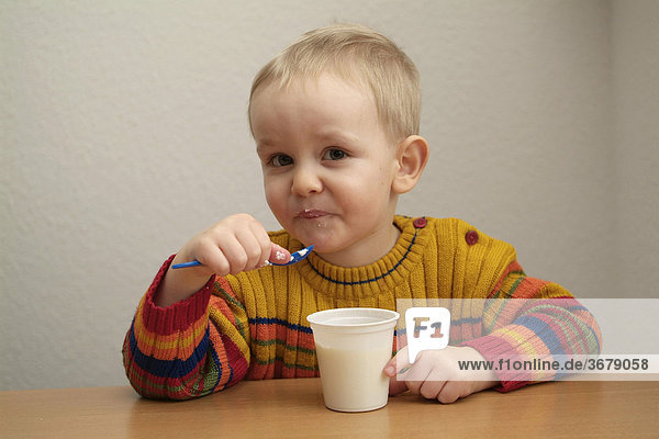 Kind isst joghurt
