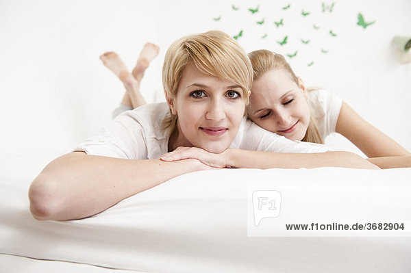 Women lying on bed