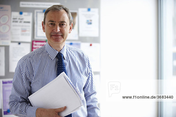 Male Medical consultant holding papers