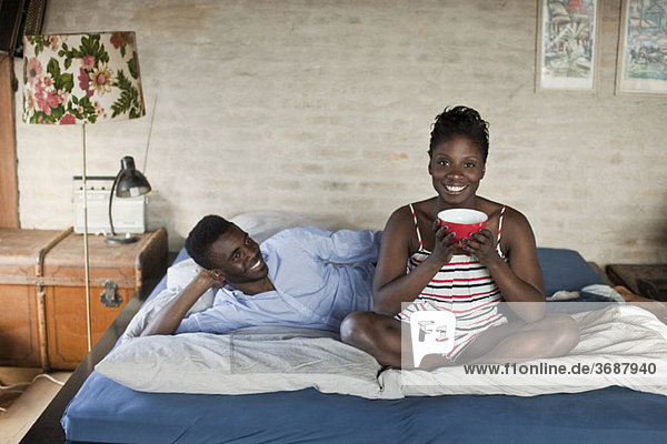 A young couple relaxing in bed
