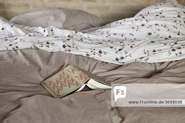 An open book on a bed
