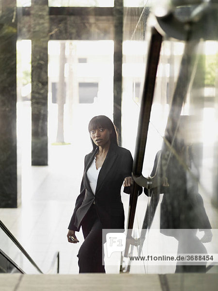 A businesswoman standing on a staircase