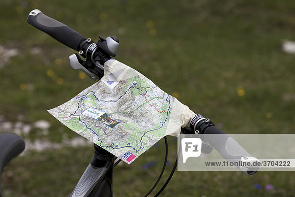 Map taped to a bicycle handlebar