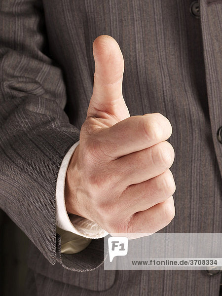 Business man giving the thumbs up for an OK