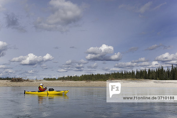 Young woman in kayak  paddling  kayaking  upper Liard River  Yukon Territory  Canada