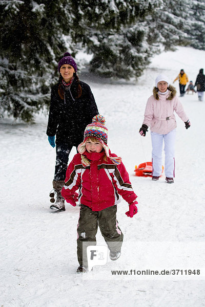 Children and adults going sledding