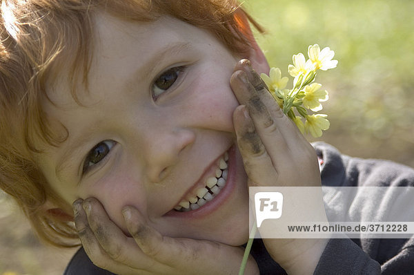 Child in spring is happy over the first flowers