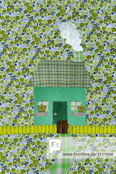 Grünes Haus mit Lattenzaun