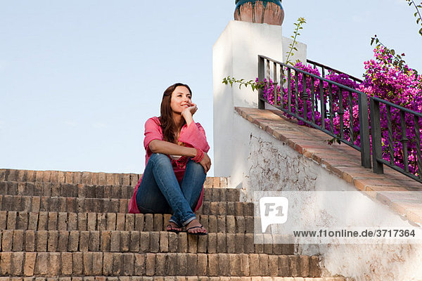 Young woman sitting on steps