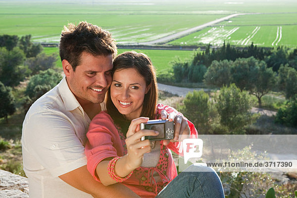 Young couple photographing themselves