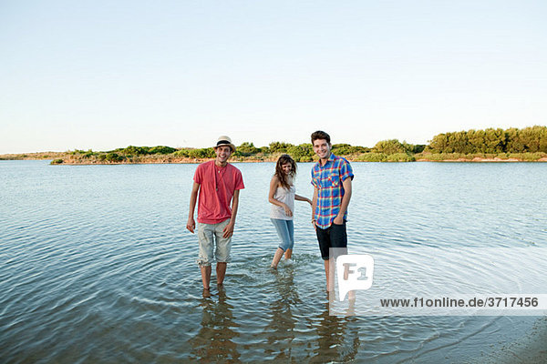 Three friends having fun in lake