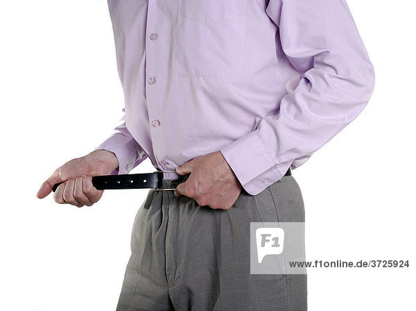 Business man tightening his belt during tough economic times  conceptual shot