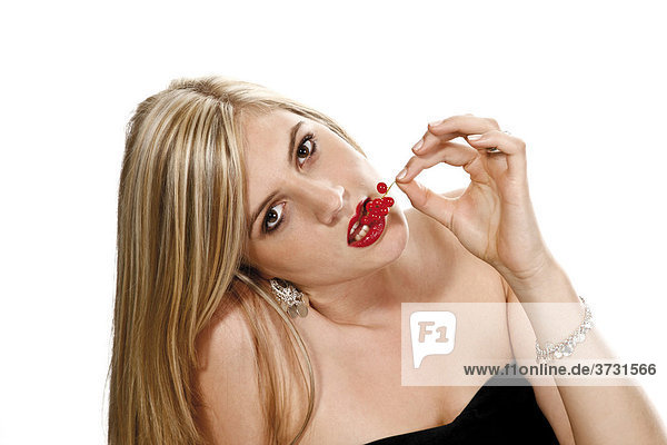 Young woman eating currants