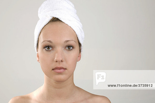 Young woman  towel wrapped around her head