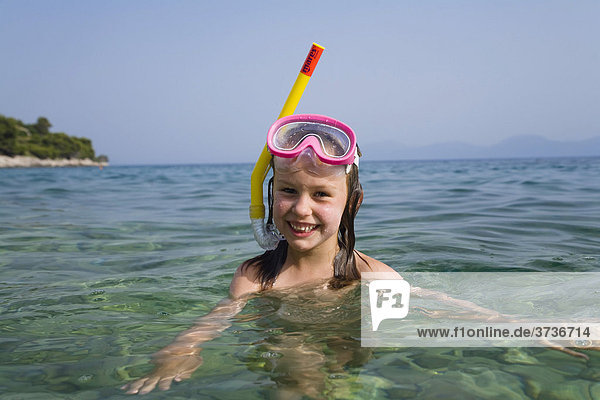 Girl with diving goggles and a snorkel  6 years old  Makarska  Dalmatia  Croatia  Europe