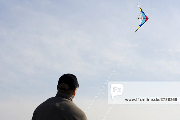 Young man with a steering kite  letting kites fly
