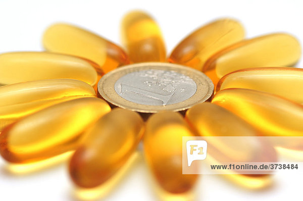 Medikament in Kapseln  blütenförmig um Ein-Euro Münze gruppiert