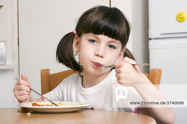 Eating little girl  6 years old  with knife and fork