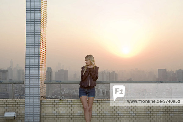 Young woman on a roof terrace in Shanghai  China  Asia