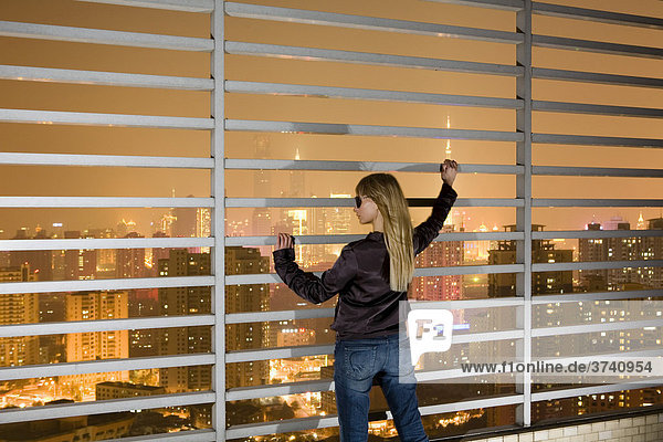 Young woman taking in the magnificent skyline of Shanghai  China  Asia