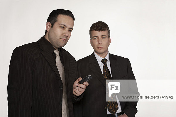Two businessmen looking at the camera