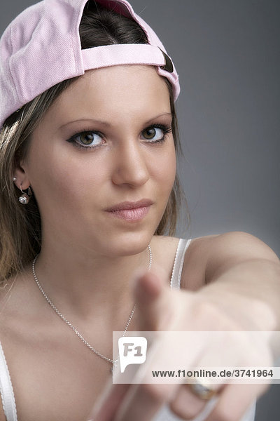 Young woman pointing her finger at the camera