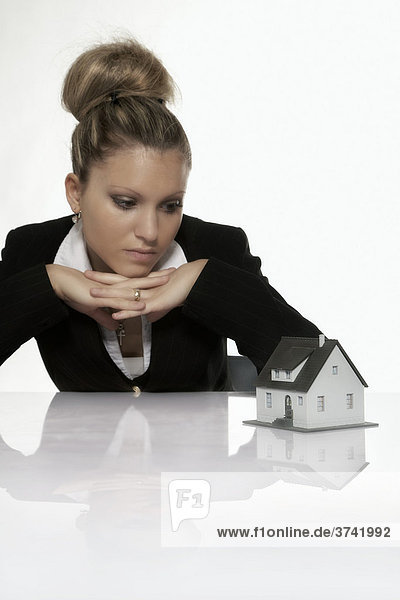 Businesswoman looking at a model house