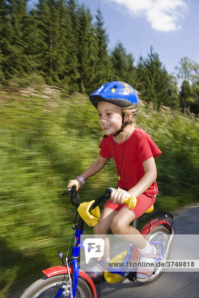 Young girl riding a bike  Bavaria  Germany  Europe