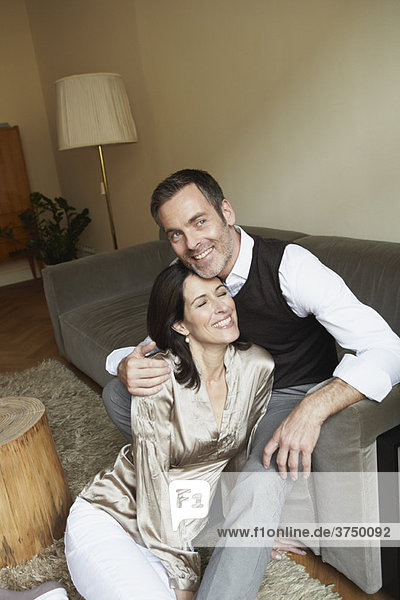 Couple snuggling on couch