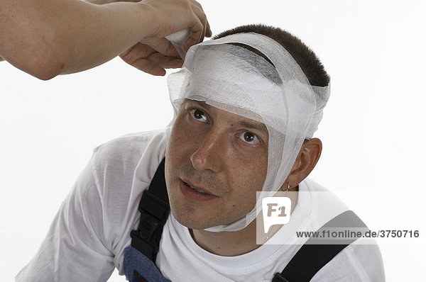 Man¥s head being bandaged  dressed