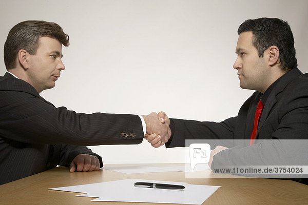 Zwei Geschäftsleute beschliessen mit Handschlag ihren Vertrag