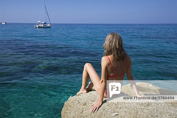 Woman sunbathing on a rock  Spiaggia di San Andrea  Elba  Italy  Europe