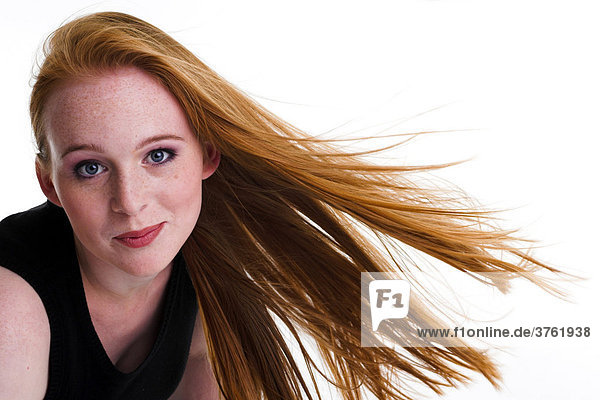 Portrait einer rothaarigen mit Sommersprossen und wehenden Haaren