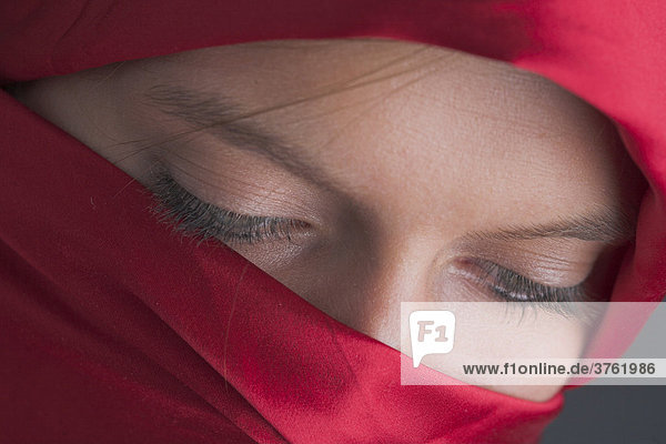 Veiled  young woman looking down