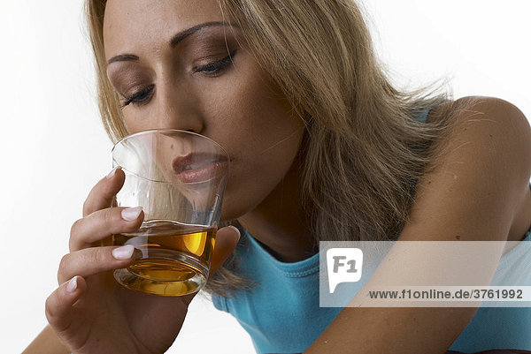 Young woman drinking brandy