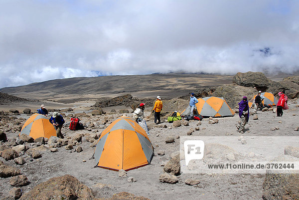 Group of trekkers with tents at School Hut Camp Kikelewa Route Kilimanjaro Tanzania