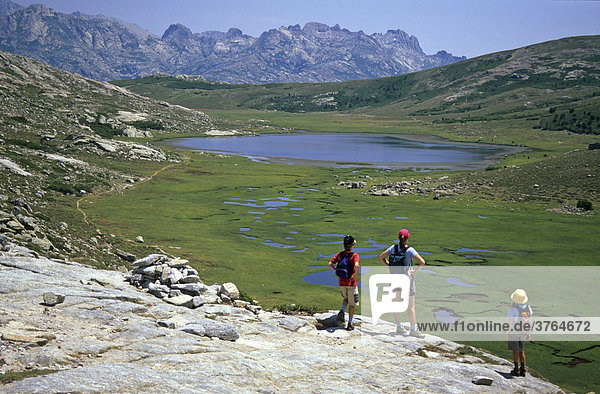 'Hikers at the lake de Nino along the trekking route GR 20