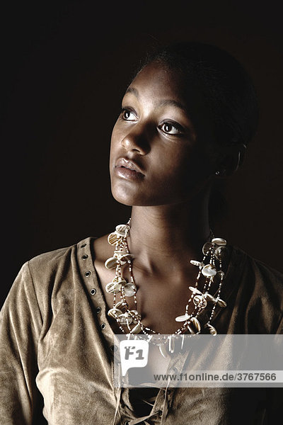 Young dark-skinned woman with necklaces